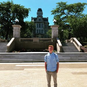 Summer College student standing on campus in front of the Hall of Languages