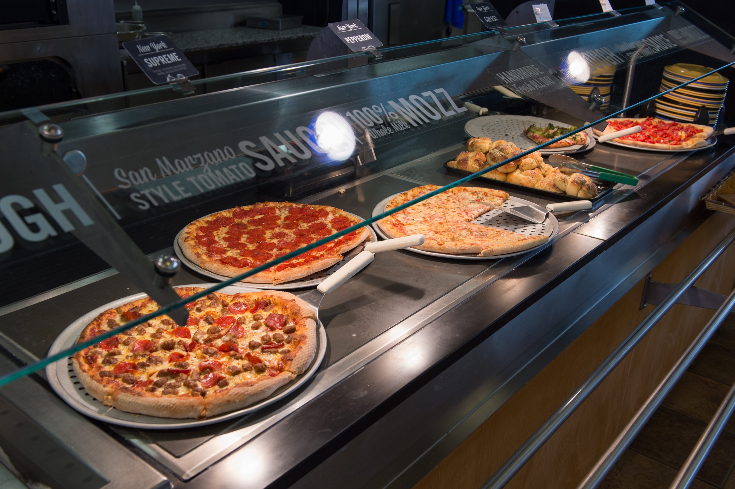 Several types of pizza with a variety of toppings at one of the dining halls.