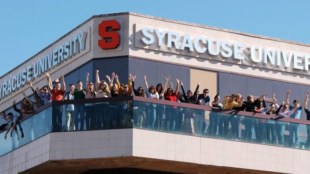 SULA Building with many students outside waving