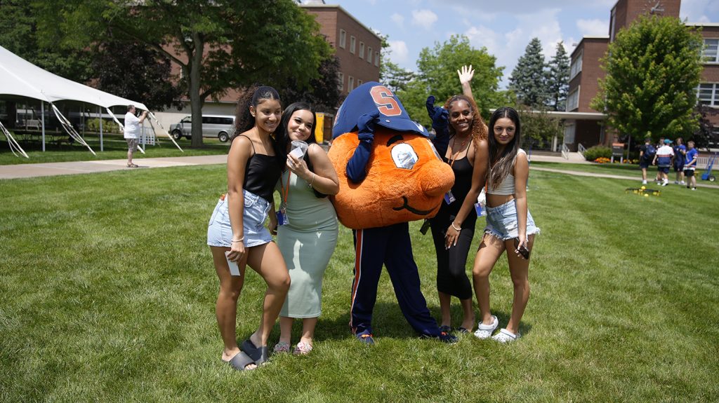 Four Summer College students pose with Otto. 