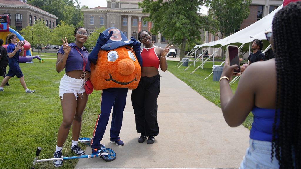 Two Summer College students pose with Otto.