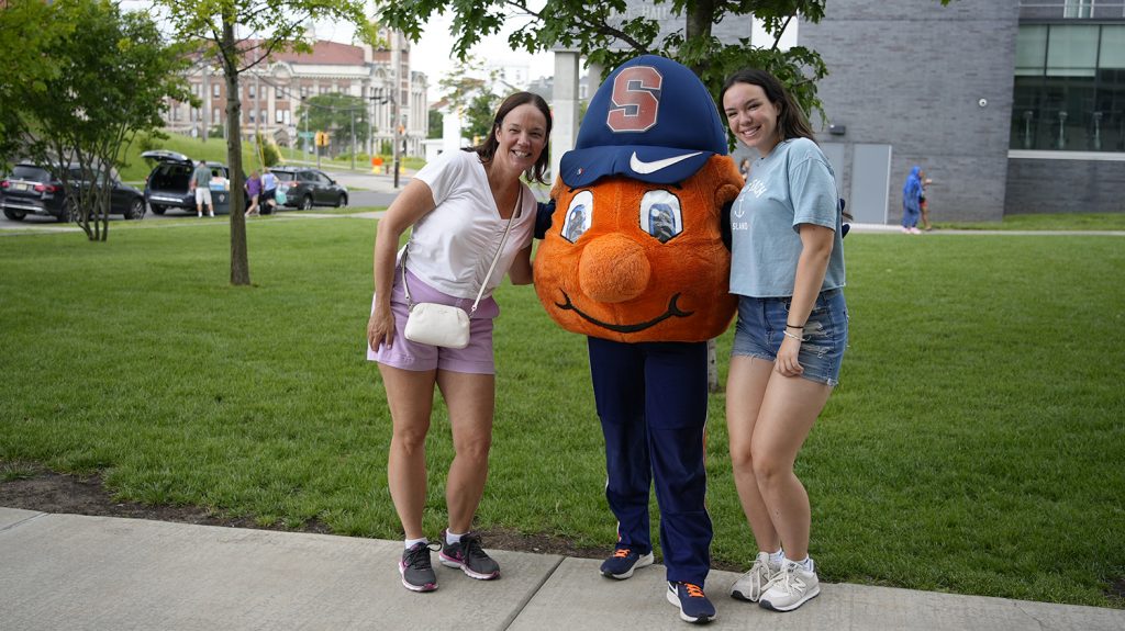 Otto poses with a Summer College student and parent. 