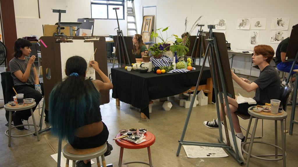 Students illustrate a still life during the observational drawing class. 