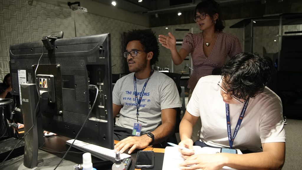 Summer College students work at a computer during the sound engineering and audio production class. 